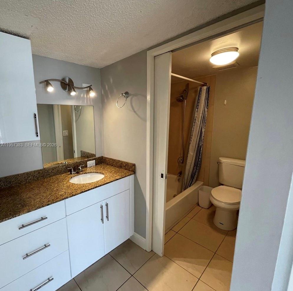16909 North Bay Road, Unit 807 Sunny Isles Beach, FL 33160 - Photo 10 of 15 a spacious bathroom with a granite countertop sink toilet and shower