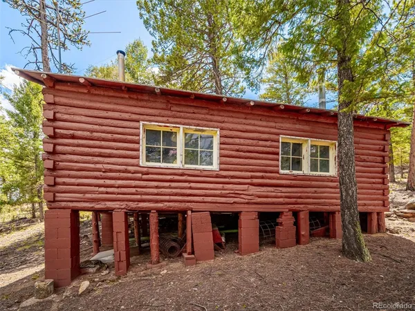 a front view of a house with a tree