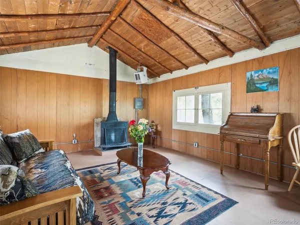 a living room with furniture a flat screen tv and a window