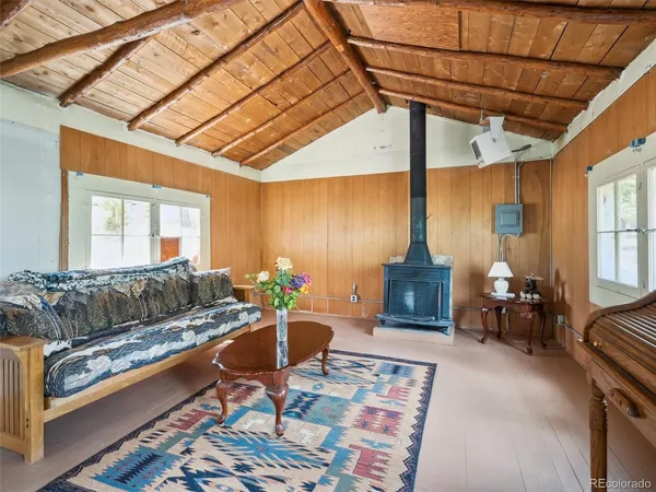 a living room with furniture a fireplace and a table