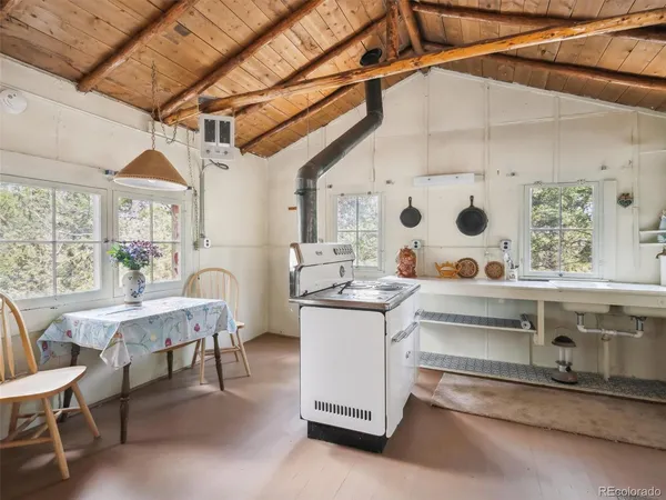 a living room with stainless steel appliances kitchen island granite countertop furniture and a window