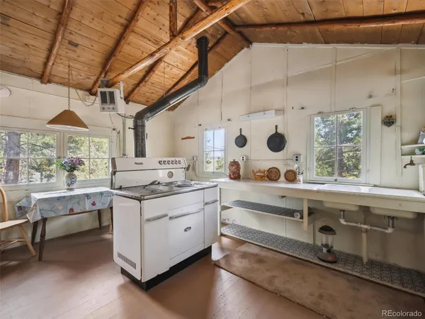 a view of a kitchen with a sink and a large window