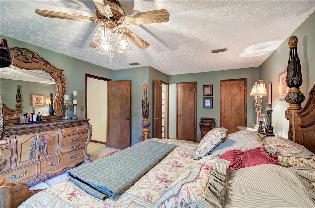 3637 Nebo Road Hiram, GA 30141 - Photo 34 of 63 a bedroom with a bed and a chandelier