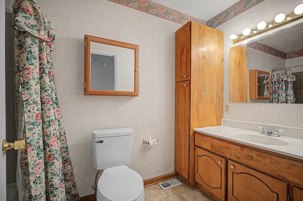 115 Brunson Drive Pickens, SC 29671 - Photo 15 of 29 Functional primary bathroom with extensive wood cabinetry for ample storage.