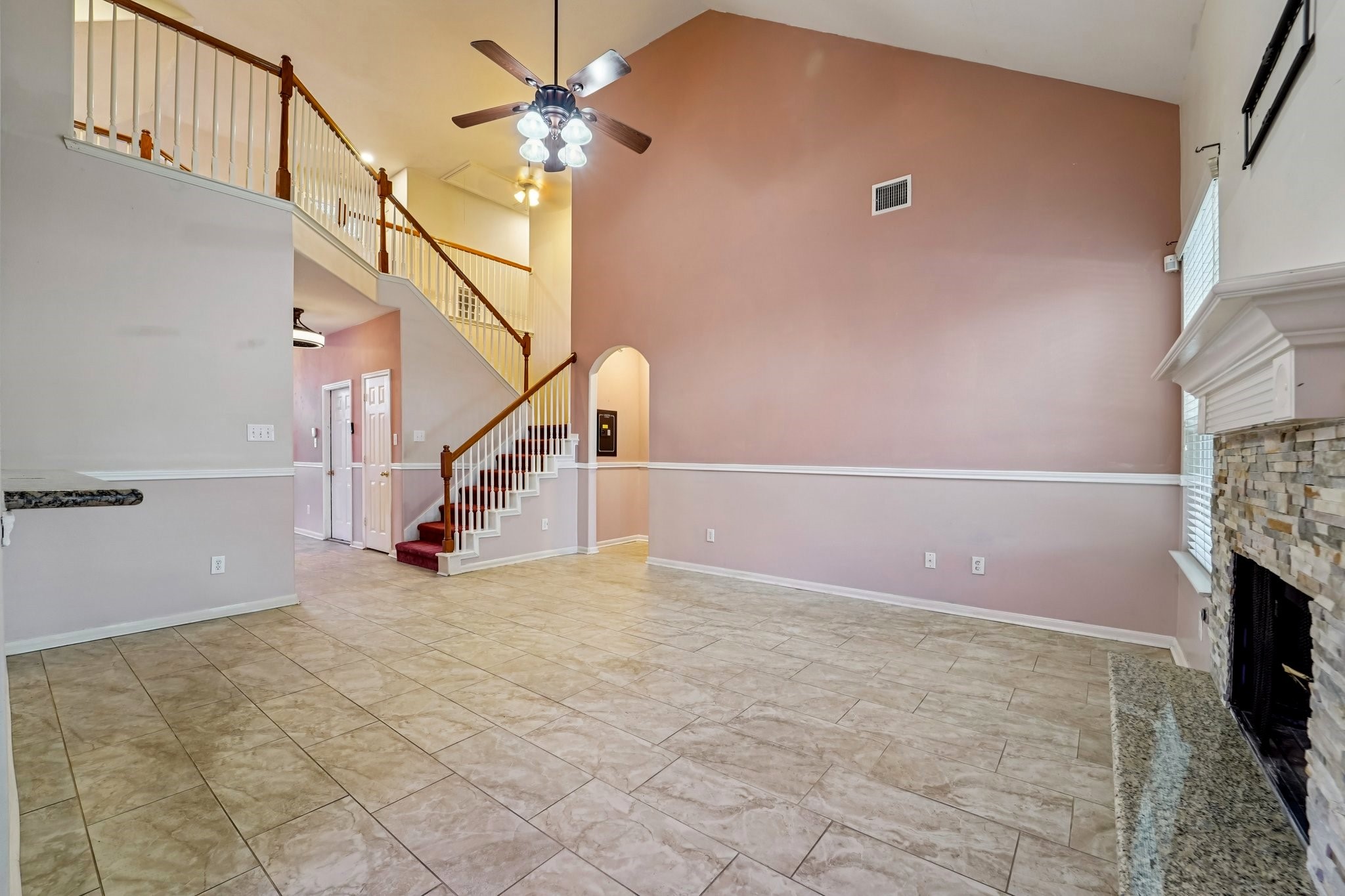 3818 Ridge Canyon Road Baytown, TX 77521 - Photo 13 of 32 a view of an empty room with stairs and a ceiling fan