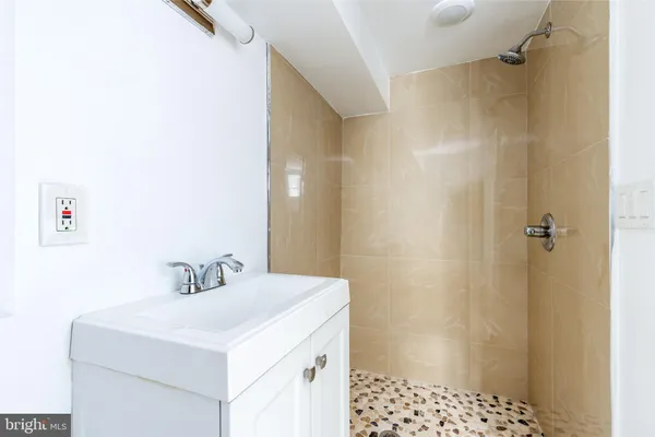 a bathroom with a sink a shower and a mirror