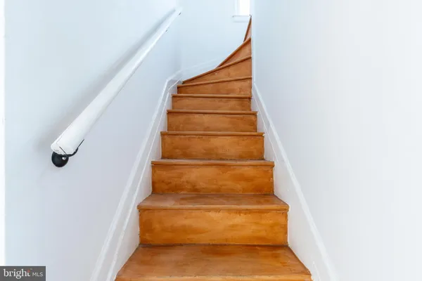 a view of staircase with white walls