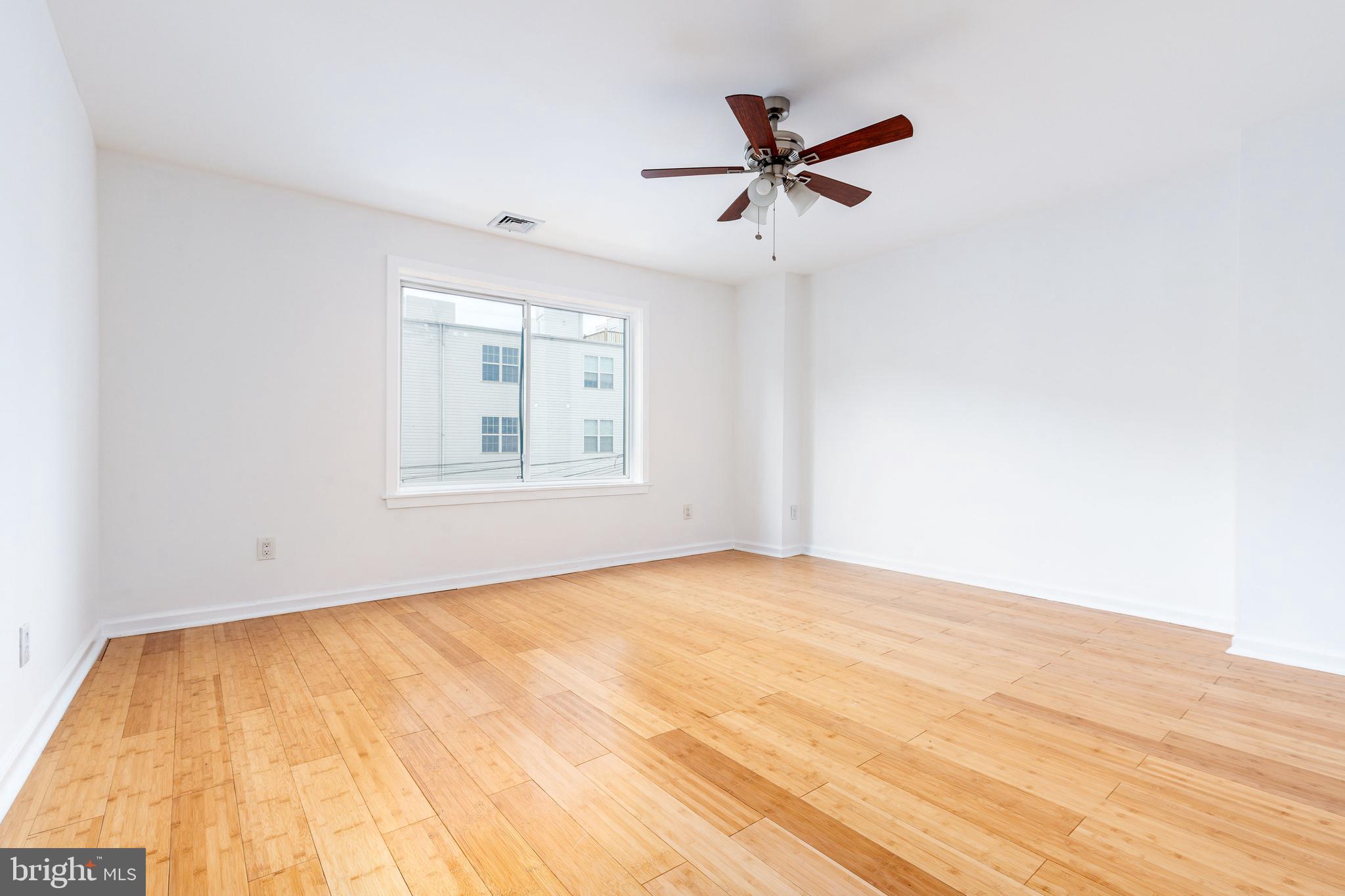 2726 Edgemont Street Philadelphia, PA 19134 - Photo 22 of 32 a view of empty room with wooden floor and fan