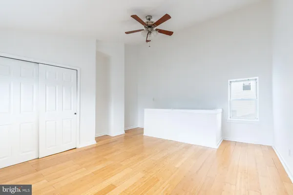 a view of empty room with wooden floor