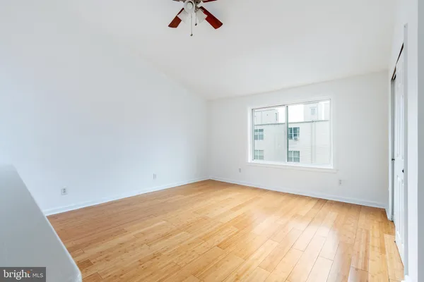 an empty room with a empty space and windows
