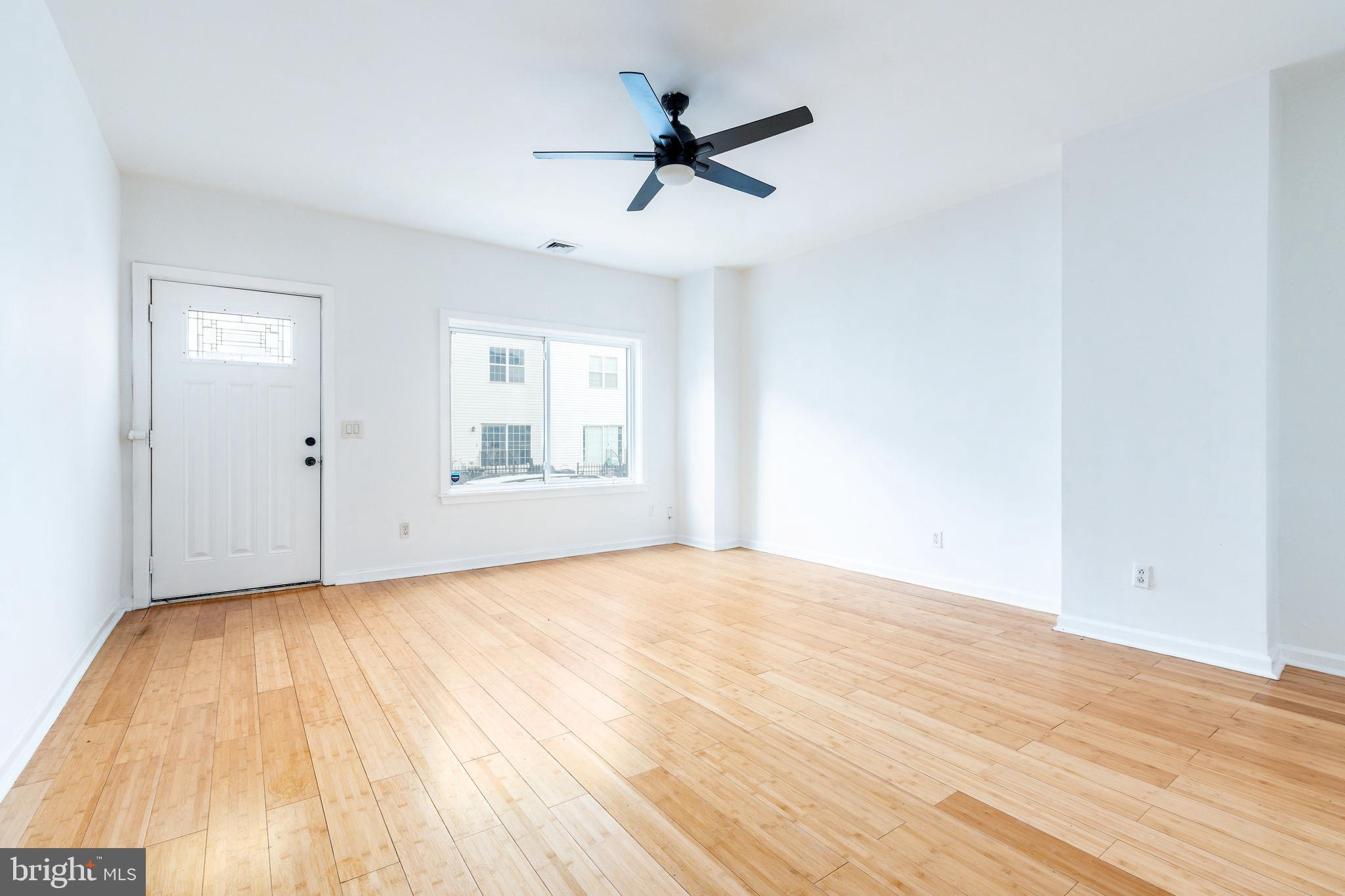 2726 Edgemont Street Philadelphia, PA 19134 - Photo 3 of 32 a view of empty room with wooden floor and fan