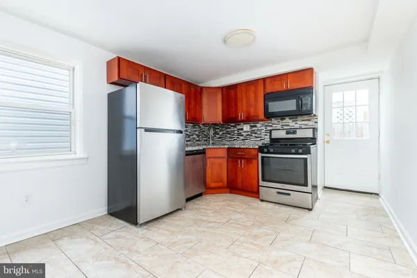 a kitchen with stainless steel appliances a stove and a refrigerator
