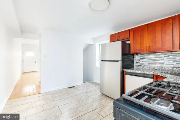 a kitchen with a stove and a refrigerator