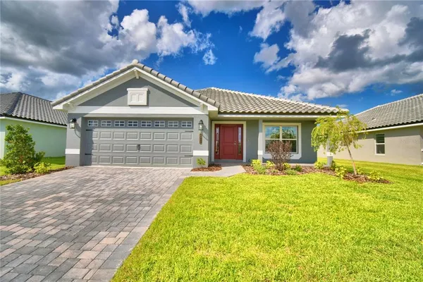 a front view of a house with a yard and garage