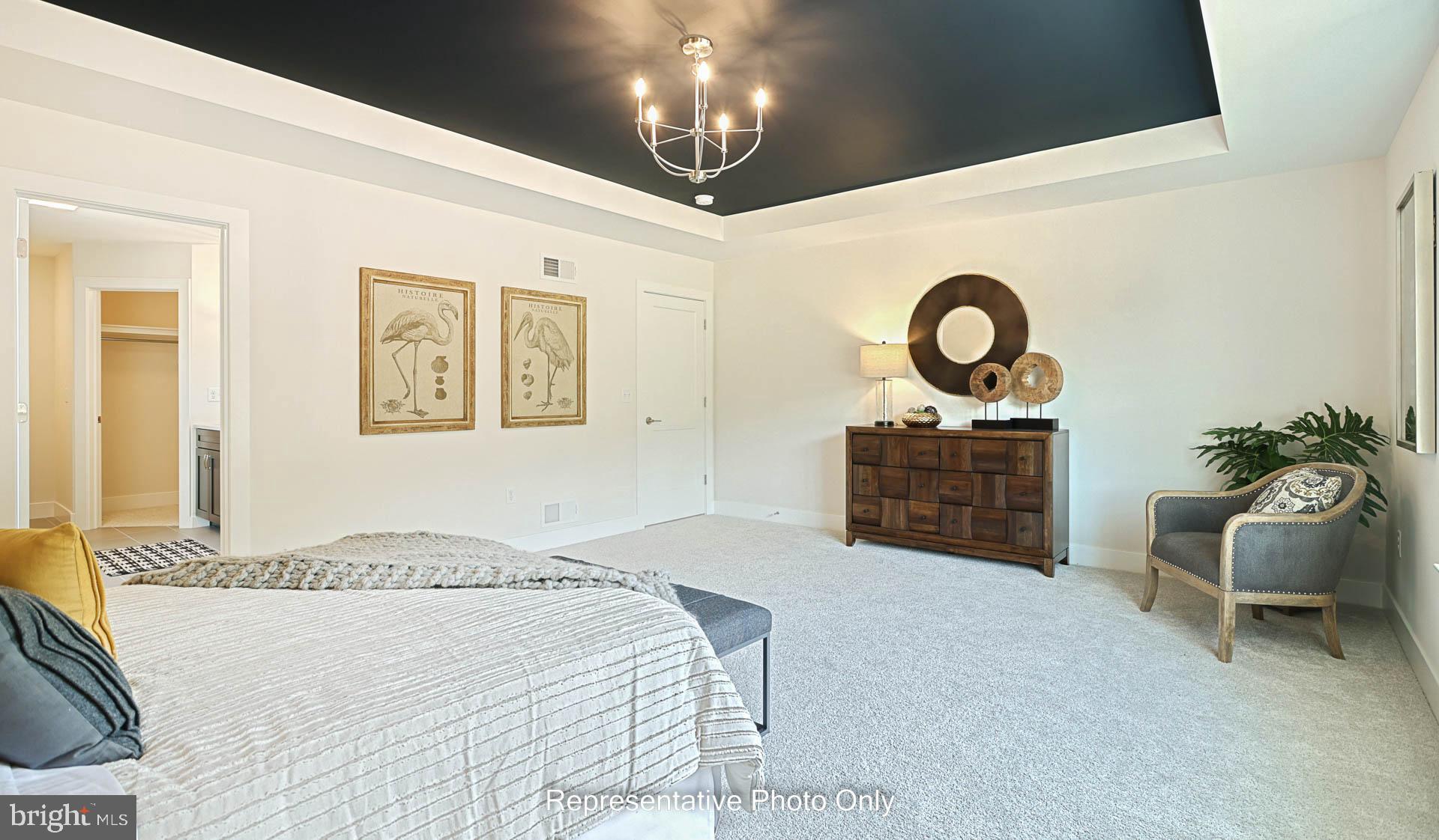 1002 Edorma Court Harrisburg, PA 17112 - Photo 22 of 30 a spacious bedroom with a bed and a chair