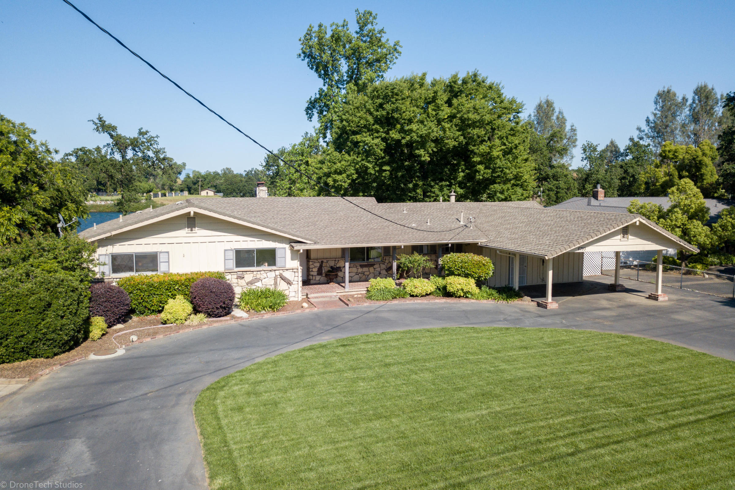 6793 Riverside Drive Redding, CA 96001 - Photo 4 of 80 a front view of a house with a yard