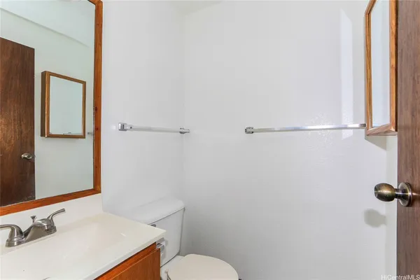 a bathroom with a sink vanity mirror and toilet
