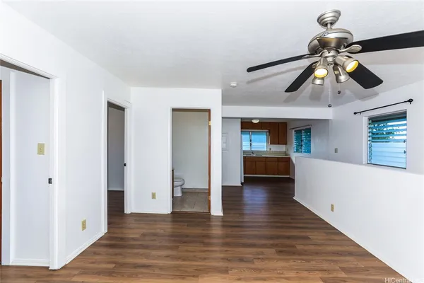 a view of hallway with wooden floor and chandelier