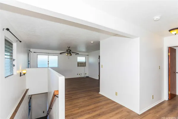 a very nice looking room with wooden floor and a window