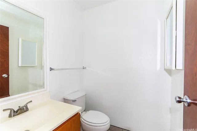 a white toilet sitting next to a bathroom sink