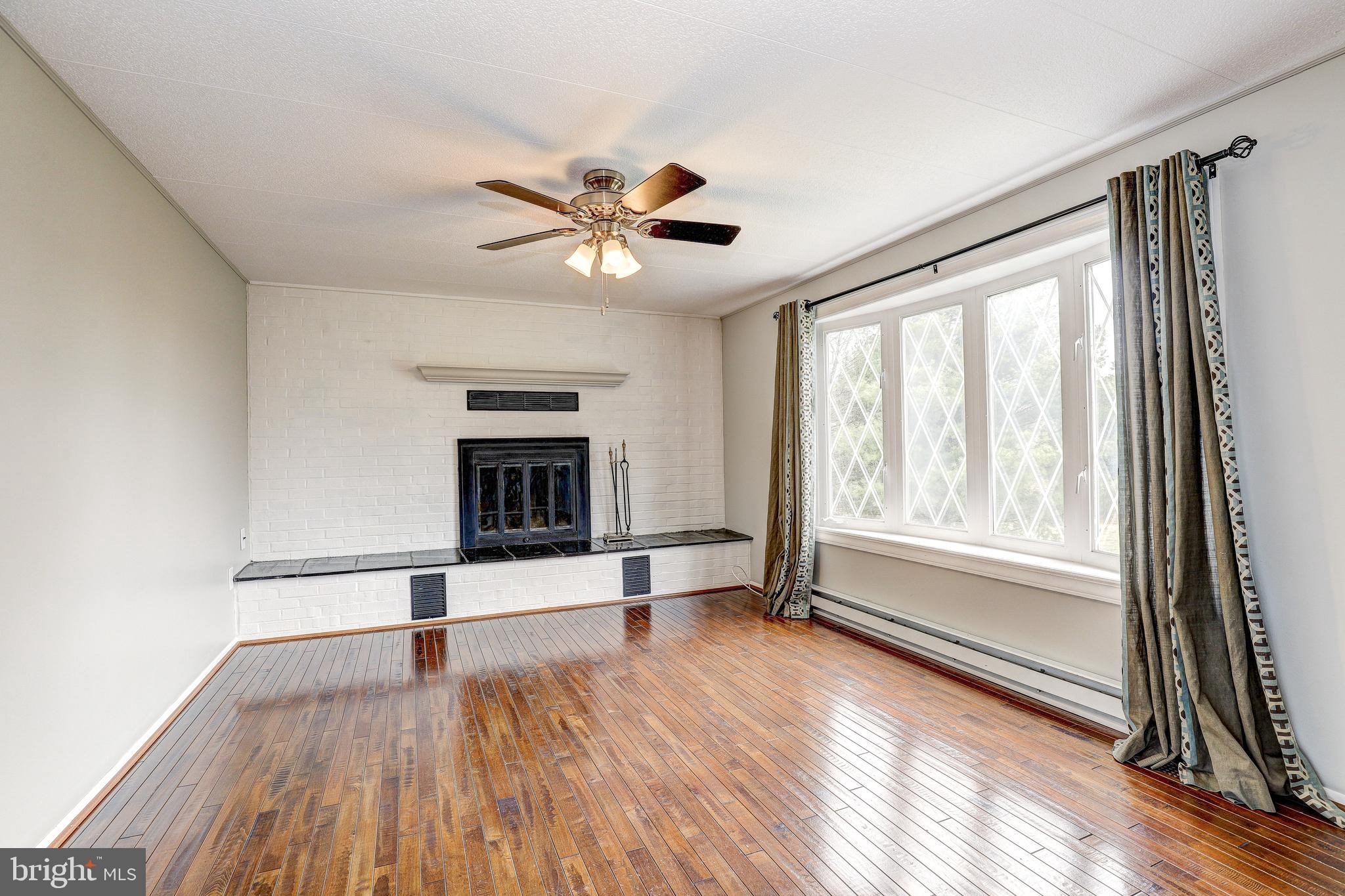 21329 Middletown Road Freeland, MD 21053 - Photo 5 of 37 a view of an empty room with a window and wooden floor