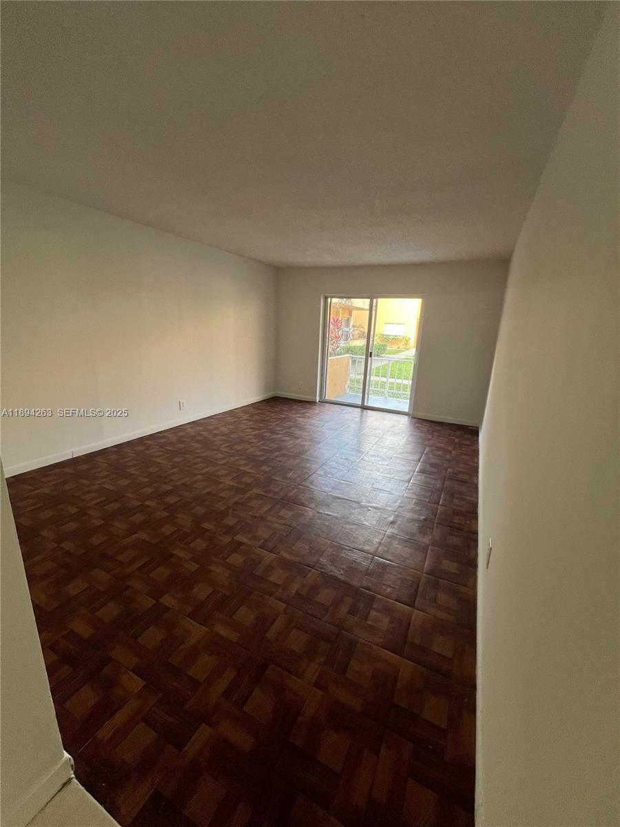 17901 Northwest 68th Avenue, Unit Q103 Hialeah, FL 33015 - Photo 1 of 33 en empty room with window