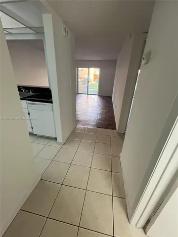 a view of an entryway and kitchen