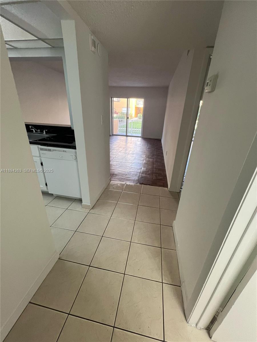17901 Northwest 68th Avenue, Unit Q103 Hialeah, FL 33015 - Photo 11 of 33 a view of an entryway and kitchen