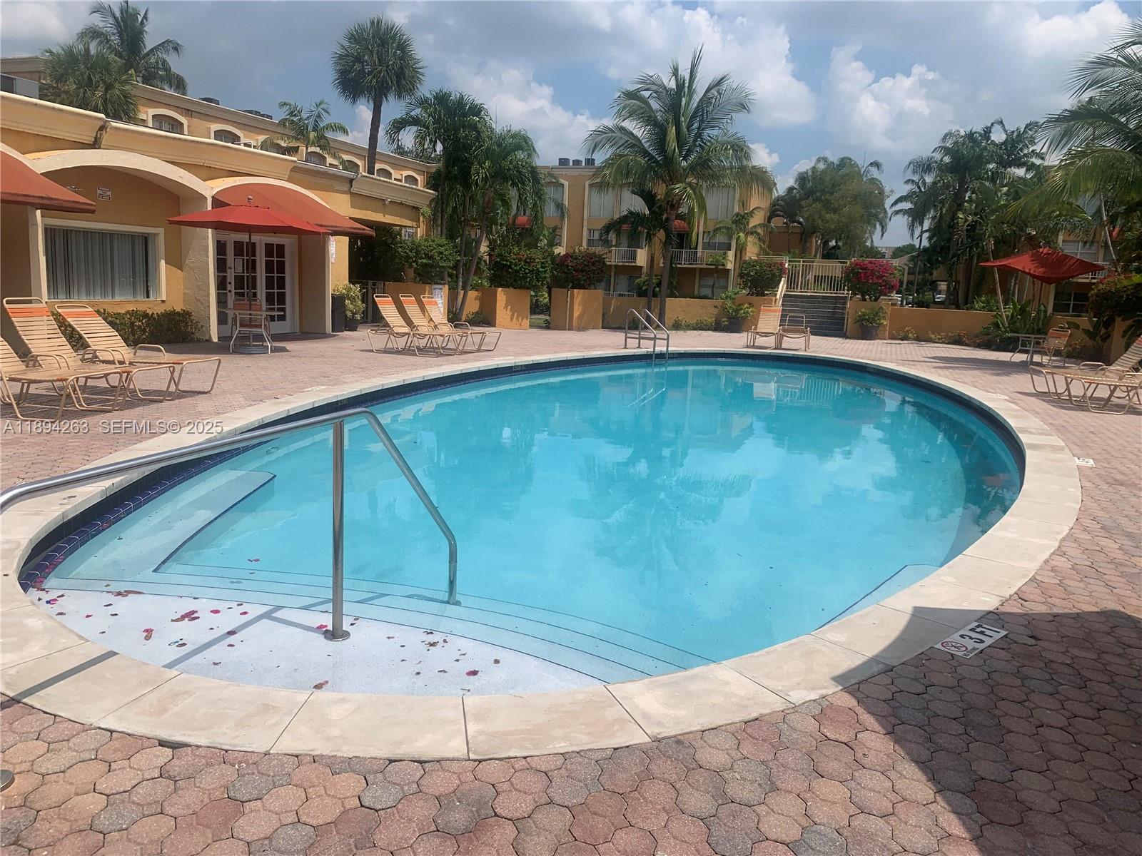 17901 Northwest 68th Avenue, Unit Q103 Hialeah, FL 33015 - Photo 15 of 33 a view of a swimming pool with a patio