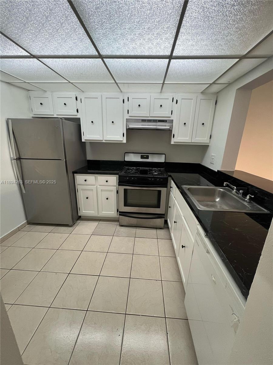 17901 Northwest 68th Avenue, Unit Q103 Hialeah, FL 33015 - Photo 4 of 33 a kitchen with stainless steel appliances granite countertop a stove a sink dishwasher and a refrigerator