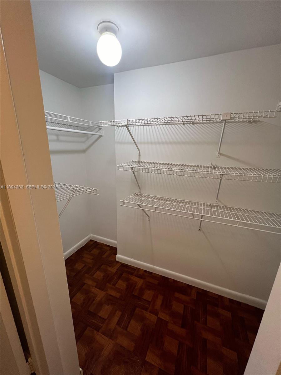 17901 Northwest 68th Avenue, Unit Q103 Hialeah, FL 33015 - Photo 5 of 33 a view of a room with racks on the wall