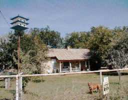 an aerial view of a house with swimming pool and outdoor space