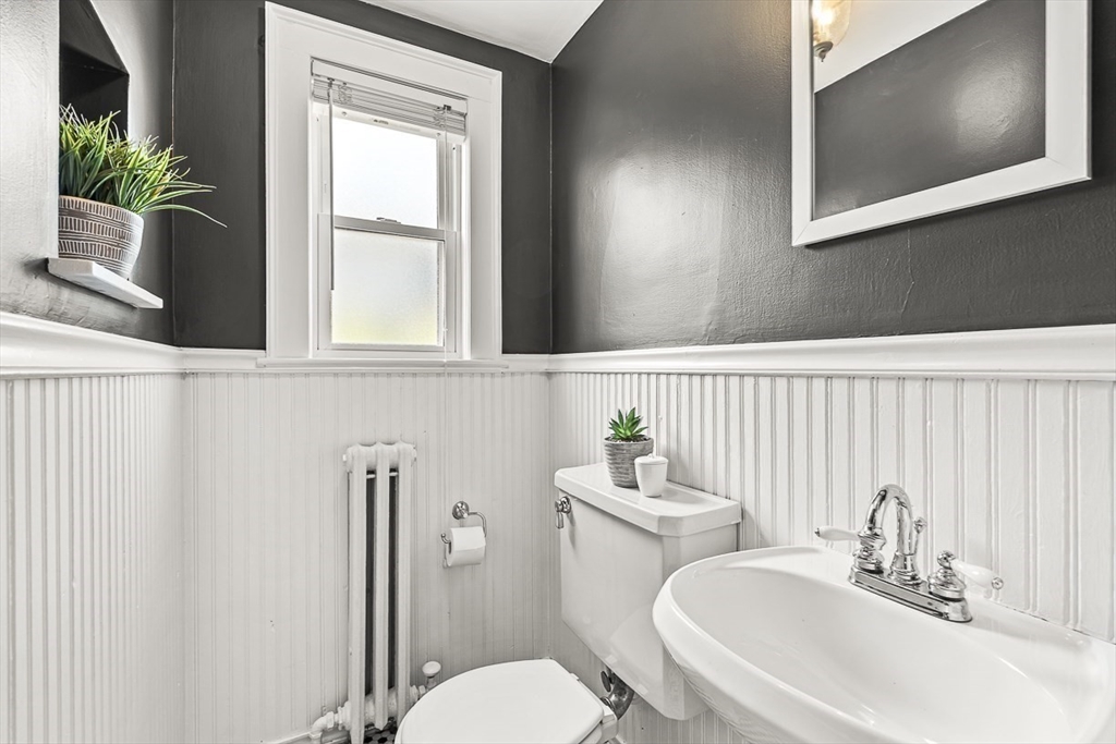 15 White Oak Road Boston, MA 02132 - Photo 12 of 24 a bathroom with a toilet a sink and a mirror