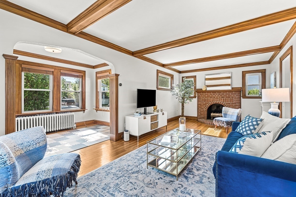 15 White Oak Road Boston, MA 02132 - Photo 5 of 24 a living room with furniture a flat screen tv and a fireplace