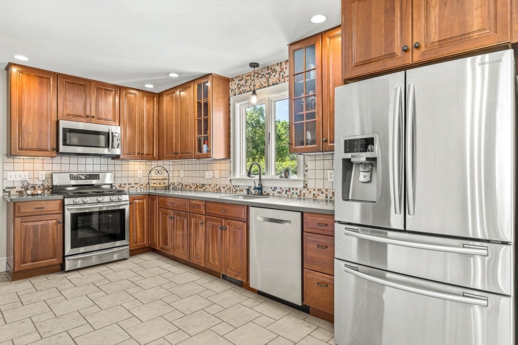 15 White Oak Road Boston, MA 02132 - Photo 10 of 24 a kitchen with stainless steel appliances granite countertop a refrigerator sink and stove