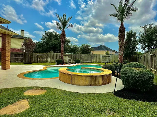 a view of a swimming pool with a yard