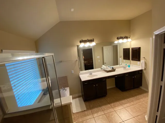a large bathroom with a double vanity sink and a mirror