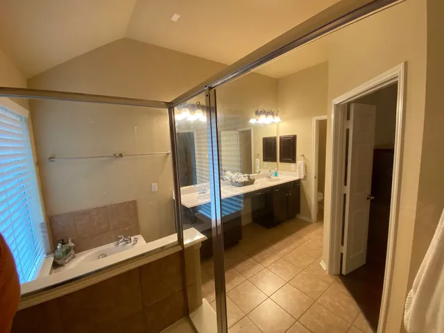 a bathroom with a double vanity sink and mirror
