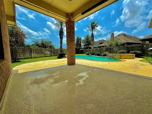 a view of swimming pool is middle in the backyard