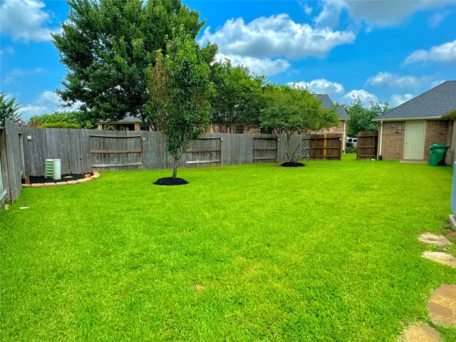 a backyard of a house with trampoline