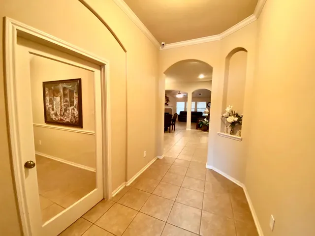 a view of a hallway with wooden floor