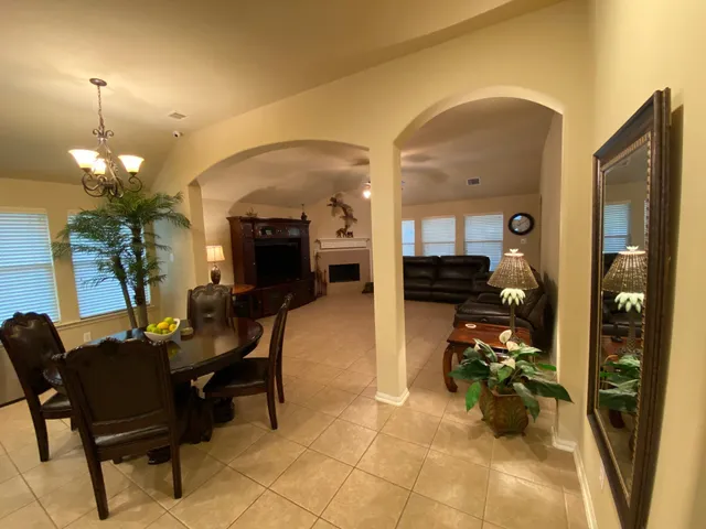a living room with furniture and a chandelier