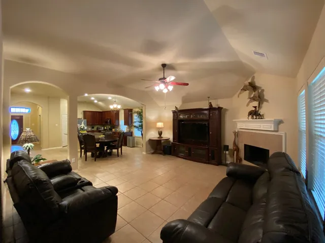 a living room with furniture a fireplace and a flat screen tv