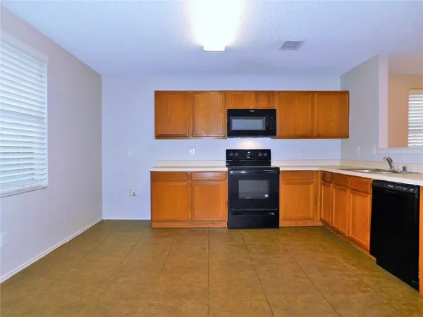 a kitchen with a stove a sink and a refrigerator