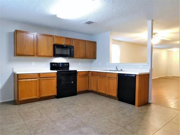 a kitchen with stainless steel appliances granite countertop a sink counter space cabinets and a window