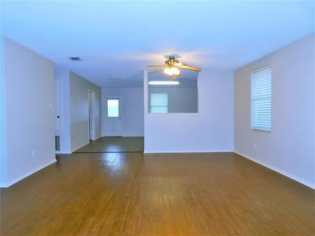 a view of empty room with window and fireplace