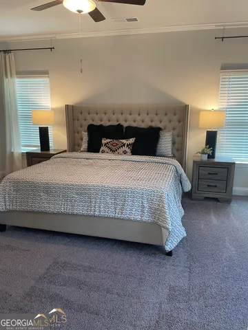 a bedroom with a bed and a night stand