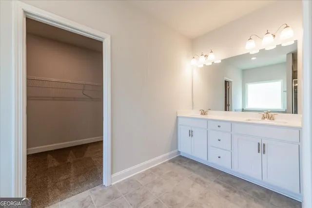 a spacious bathroom with a double vanity sink and a mirror