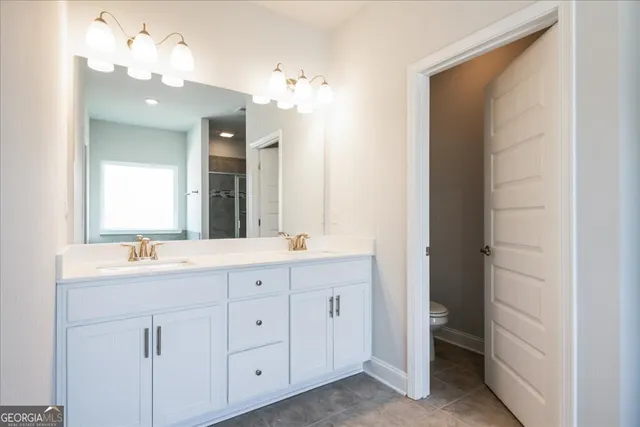 a bathroom with a double vanity sink and a mirror