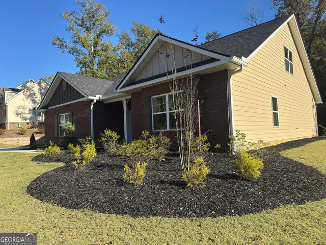 a view of a house with a yard and sitting area